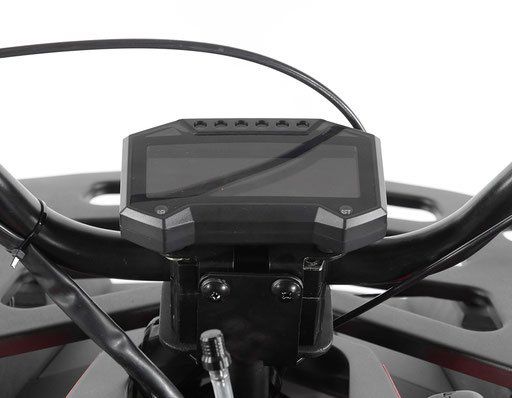 Close-up of a motorcycle handlebar-mounted digital display with cables crossing in front.