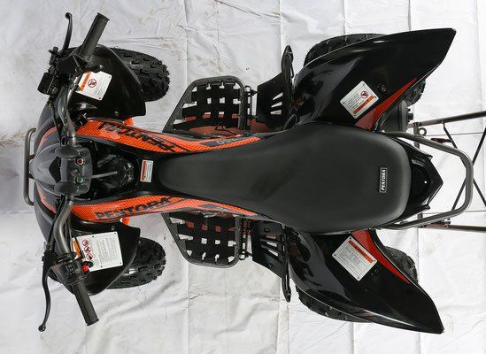 Top-down view of a black and orange all-terrain vehicle on a white backdrop