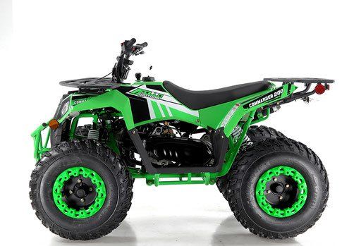 Green and black ATV with knobby tires, side view on a white background