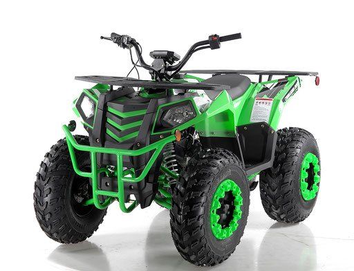 Green and black all-terrain four-wheeler ATV with large knobby tires on a white background