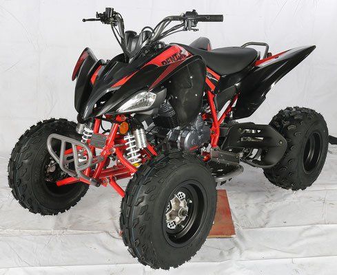 Black and red off-road ATV with large knobby tires on a white backdrop