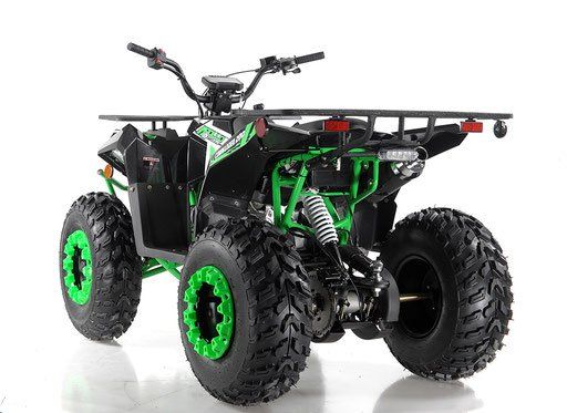 Green and black four-wheeler ATV with large knobby tires on a white background