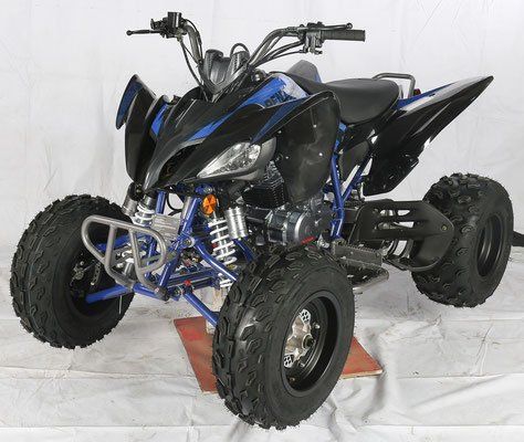 A blue and black atv is sitting on a white surface