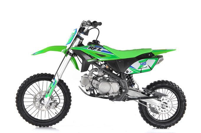 Green dirt bike on a white background, side view.