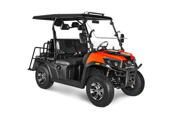 Black and orange off-road utility vehicle with a roof and cargo bed on a white background