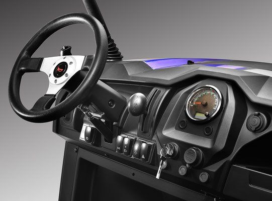 Futuristic vehicle dashboard with steering wheel, gauges, and switches in a dark interior