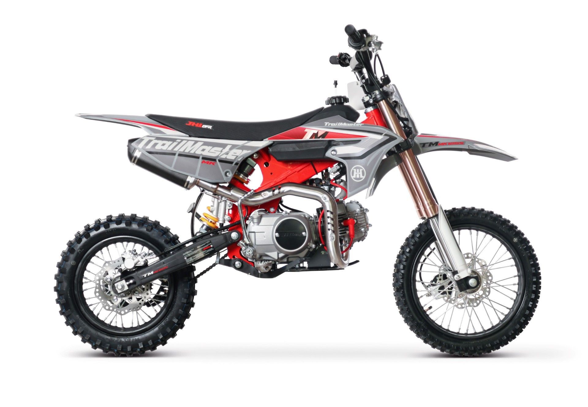 Red and black dirt bike in side view on a white background.