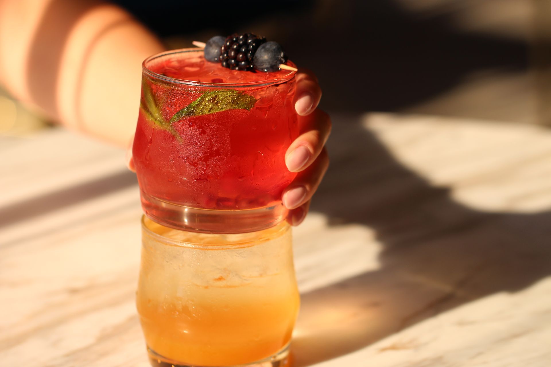 A table topped with four different types of drinks.