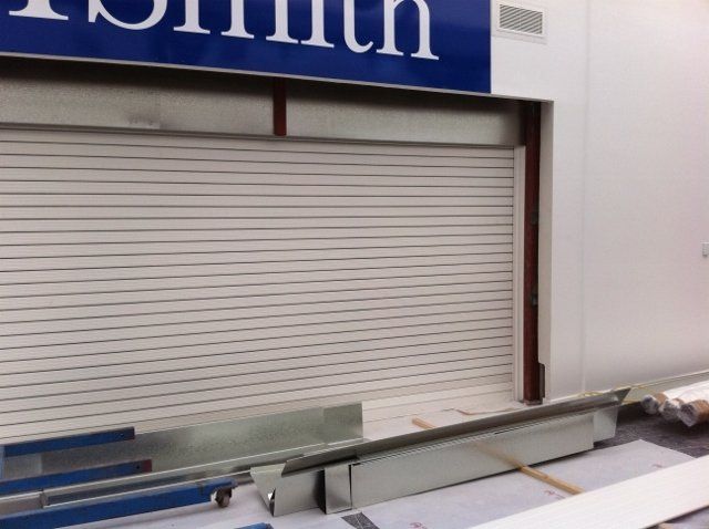 A white building with a blue sign that says ' smith ' on it