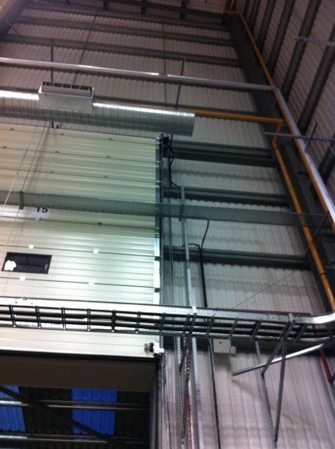 A large building with a lot of pipes hanging from the ceiling