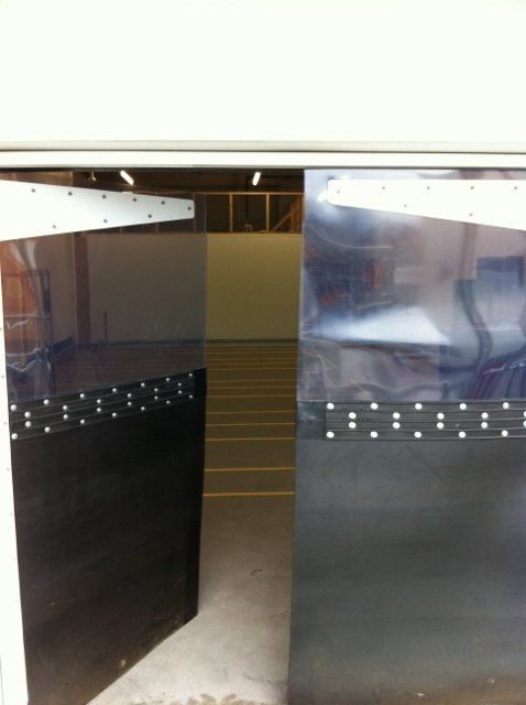A sliding glass door is open to a warehouse