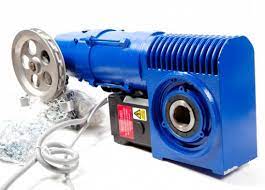 A blue motor is sitting on top of a white surface.
