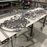 A table with a bunch of metal pieces on it.