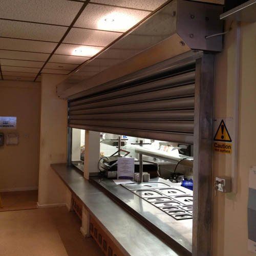 A kitchen with a sign that says caution on it