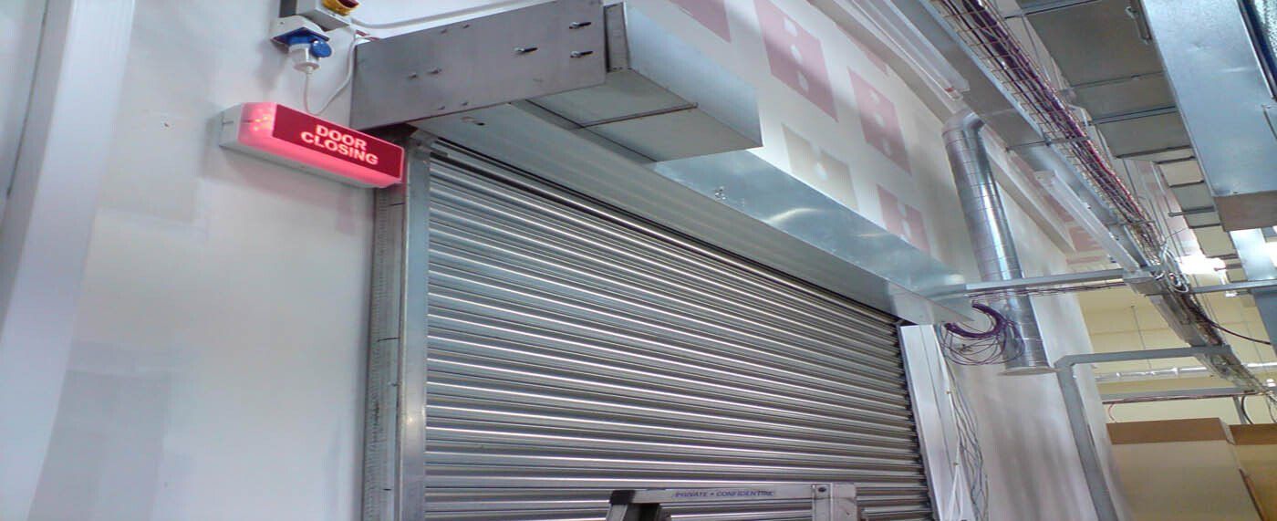 A close up of a sliding door with a red light on it.