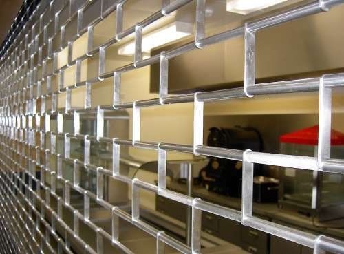A close up of a stainless steel grille in a kitchen.