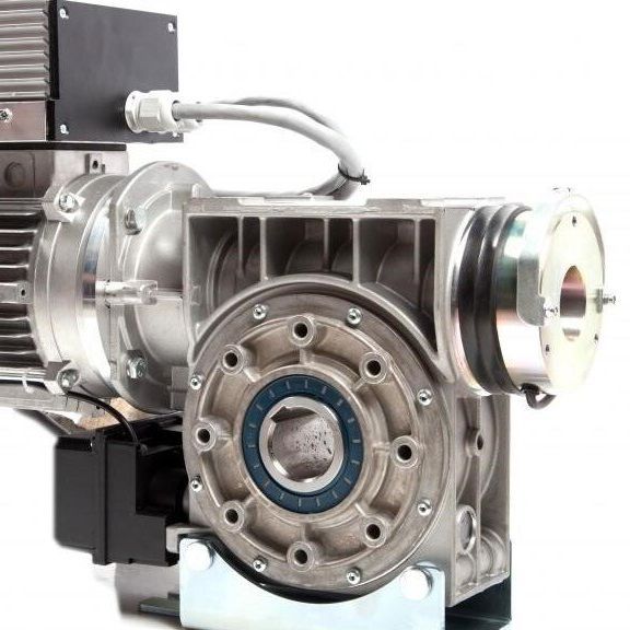 A industrial worm gear motor with a metallic housing and a central output bore, viewed from the side.