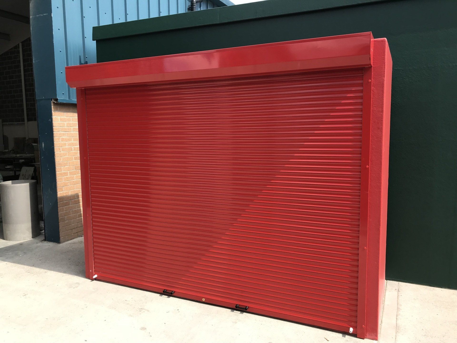 A close up of a roller shutter with a motor attached to it.