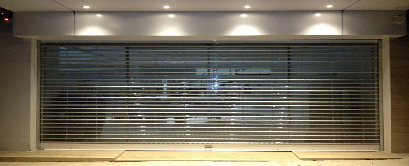 A room with a large window and a sliding glass door.