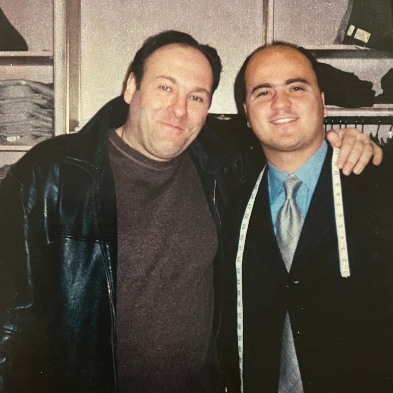 James Gandolfini stands with Michael Duru in clothing store.