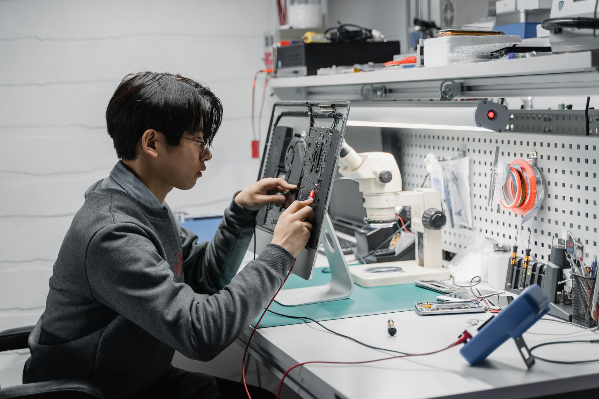 A man is sitting at a desk working on a computer.