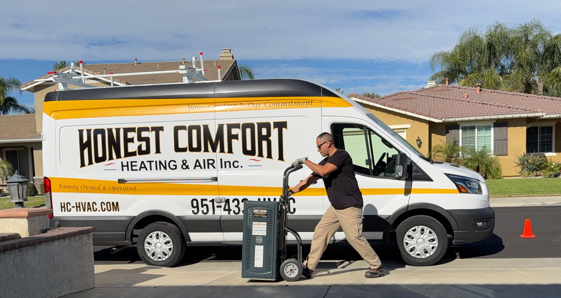 Service van for Honey Comfort Heating & Air with a technician loading equipment beside it