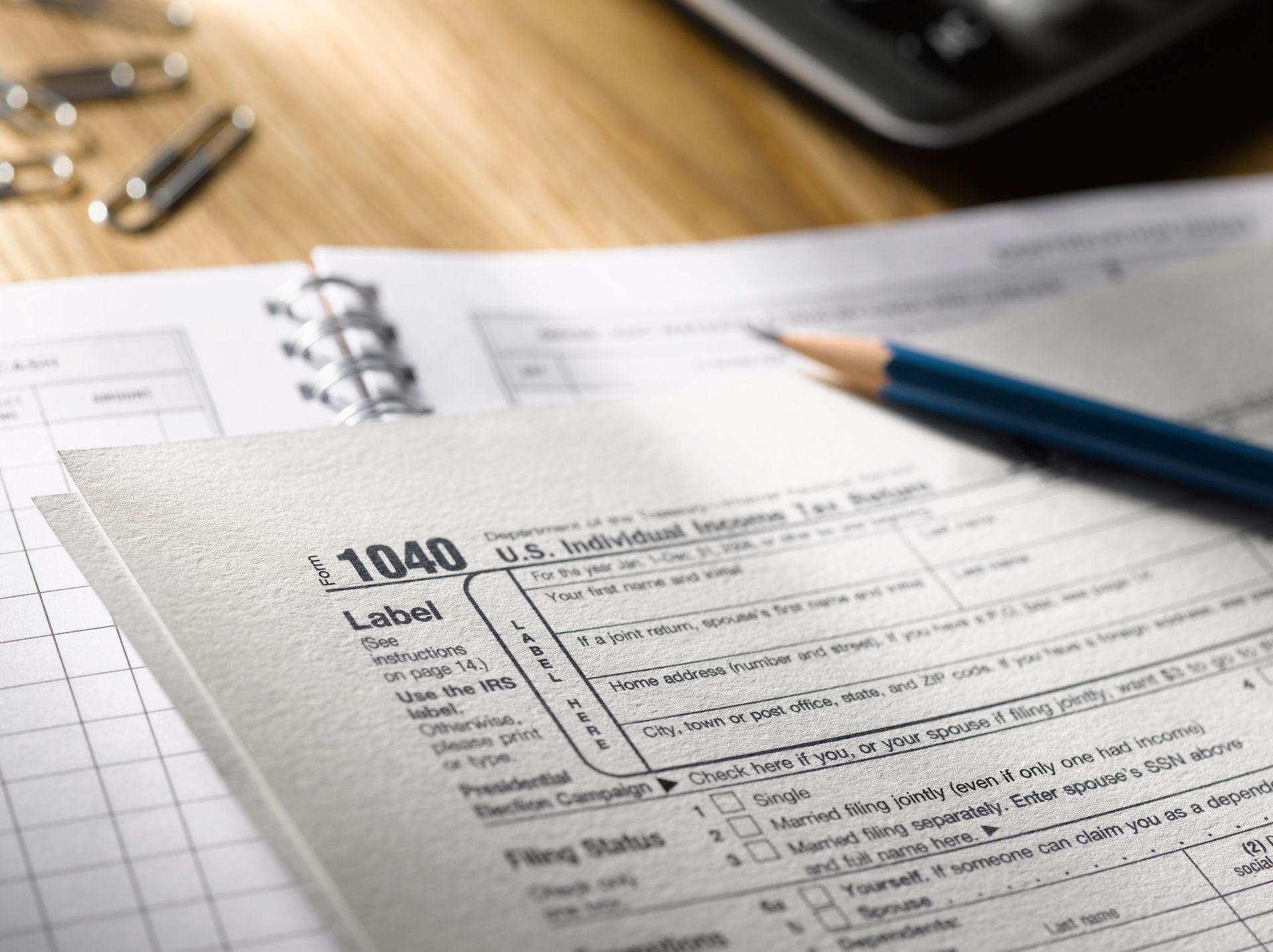 A 1040 tax form with a pencil on top of it