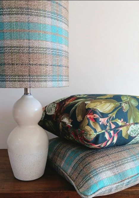 A table with a lamp and pillows on it
