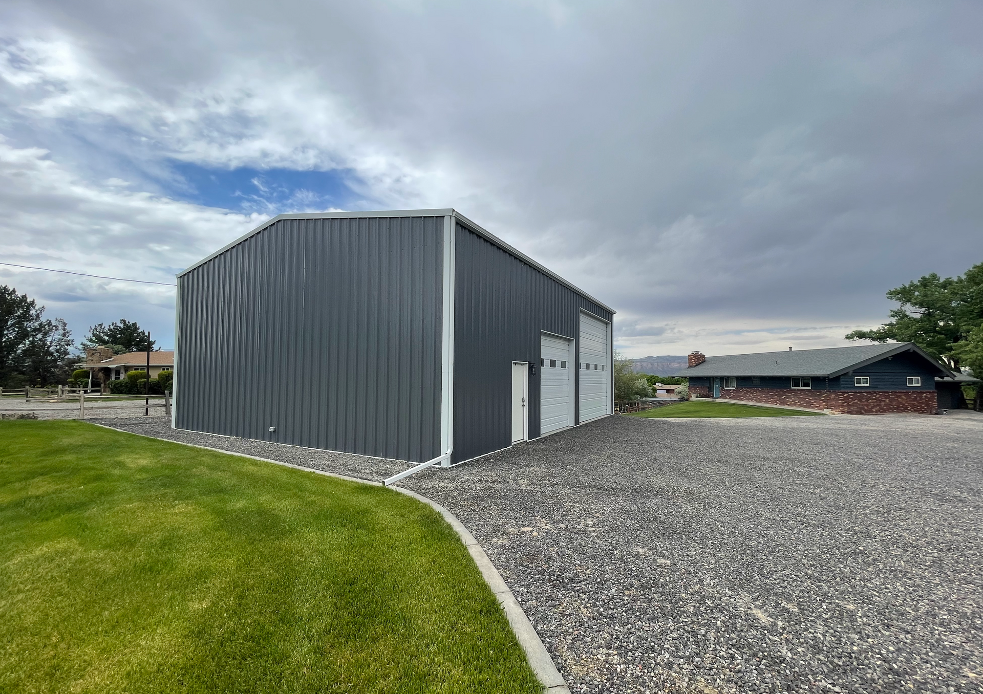 A large wooden barn with a metal roof is lit up at night.