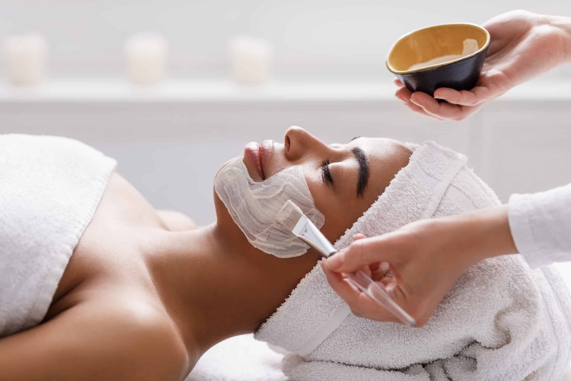 Aesthetic,Procedure.,Beautician,Applying,Clay,Face,Mask,On,Black,Woman woman getting facial treatment
