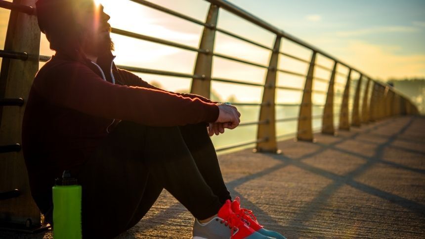 man resting from a morning jog trauma and addiction recovery