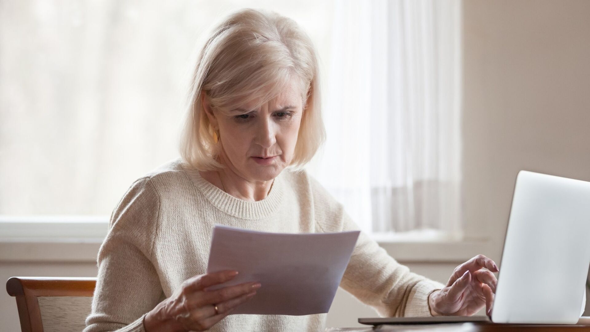 Concerned woman viewing bills. addiction enabler