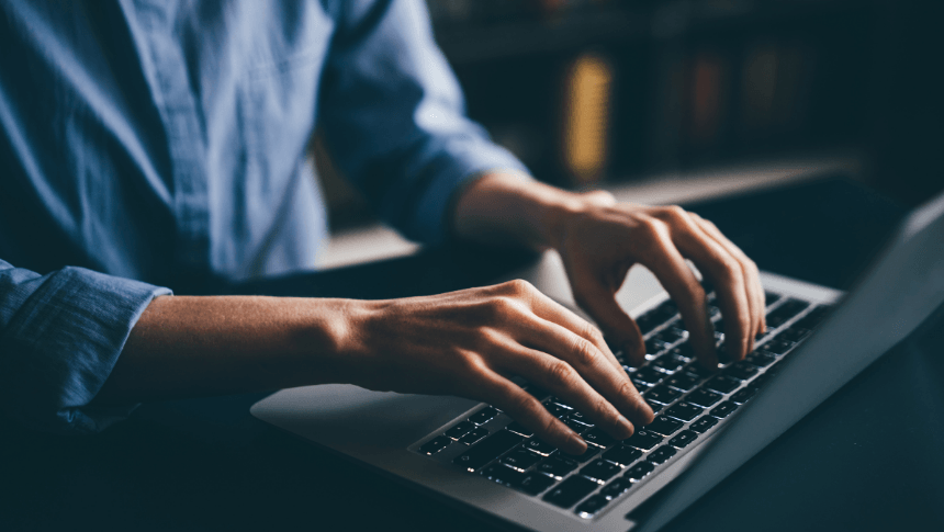 Man typing on a laptop computer. working-alone