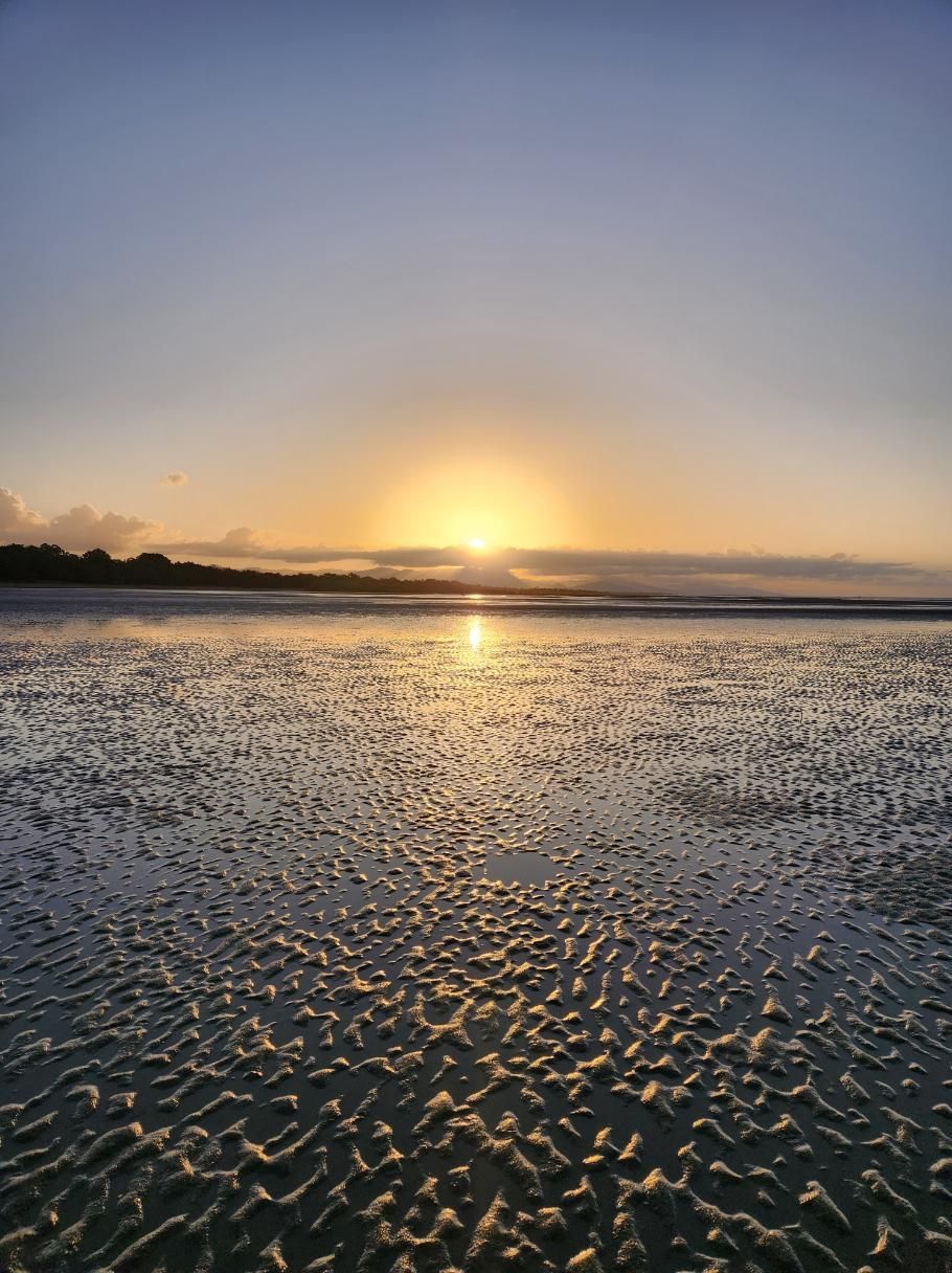The Sun Is Setting Over A Body Of Water — Coastal Gasfitting & Plumbing In Bushland Beach, QLD
