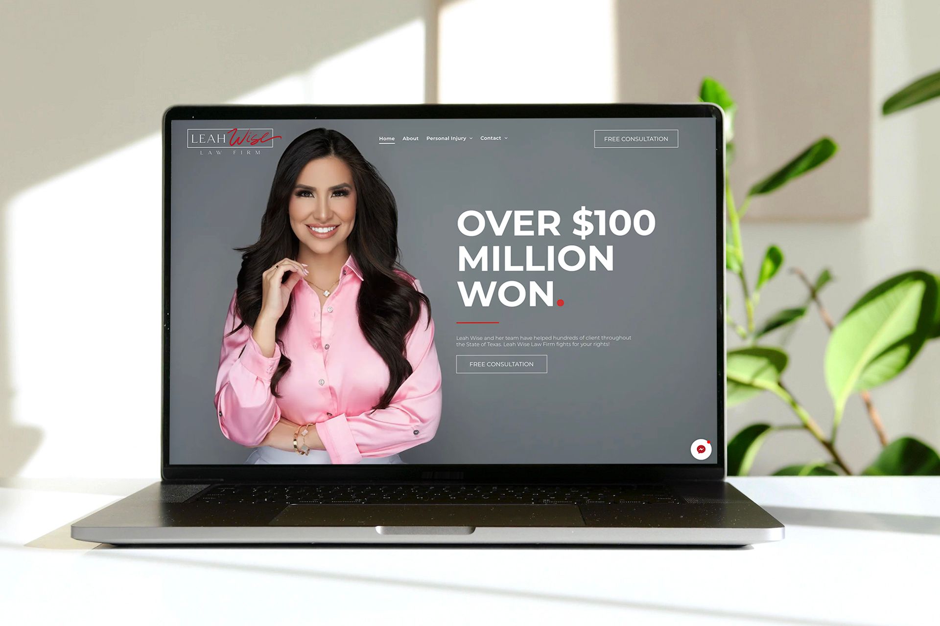 A laptop computer is sitting on a table with a woman on the screen.