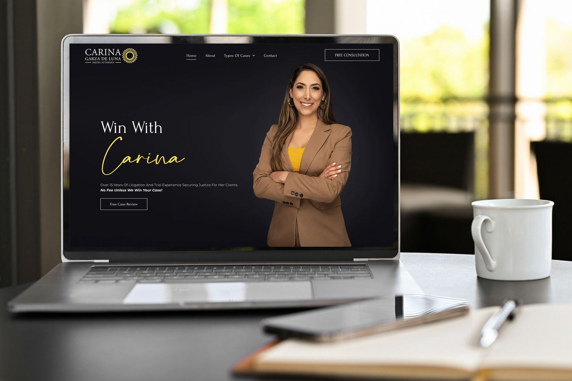 A laptop computer is sitting on a desk with a woman on the screen.