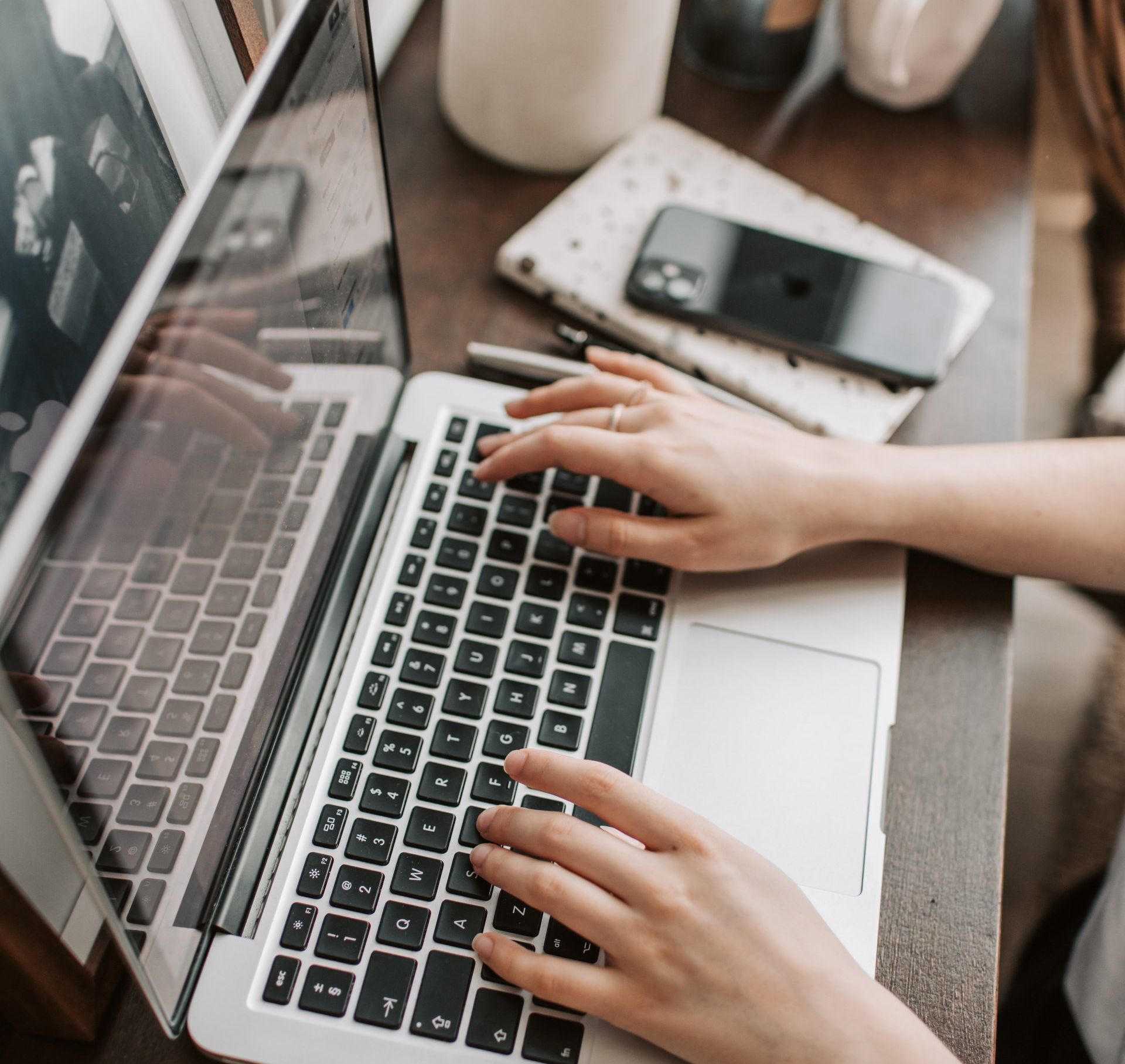 A person is typing on a laptop computer.
