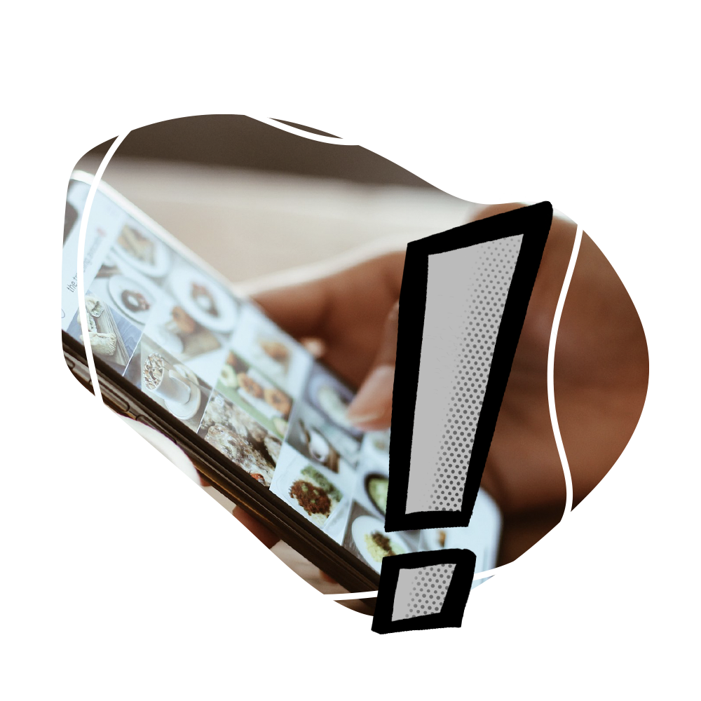 A person is holding a cell phone with an exclamation point on it.