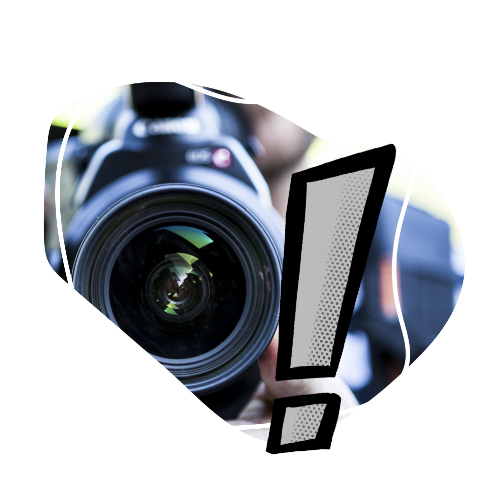 A person is holding a camera with an exclamation point in front of it