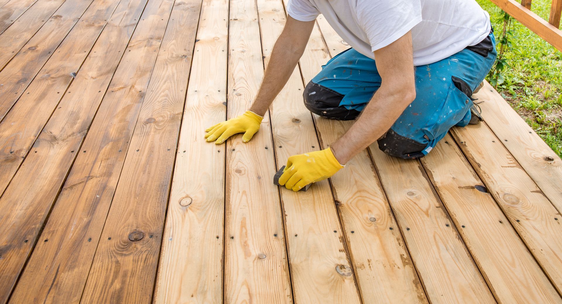 Person sanding and restoring a wooden deck, carefully smoothing boards. Person sanding and restoring a wooden deck, carefully smoothing boards.