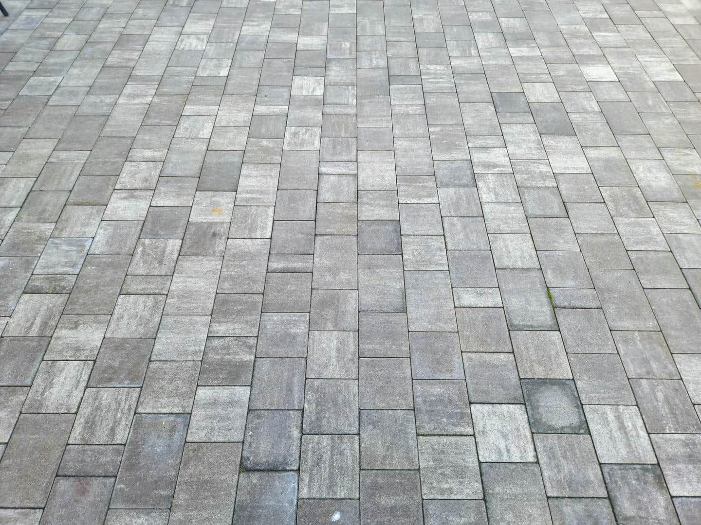 A close up of a brick pavement with a diagonal pattern
