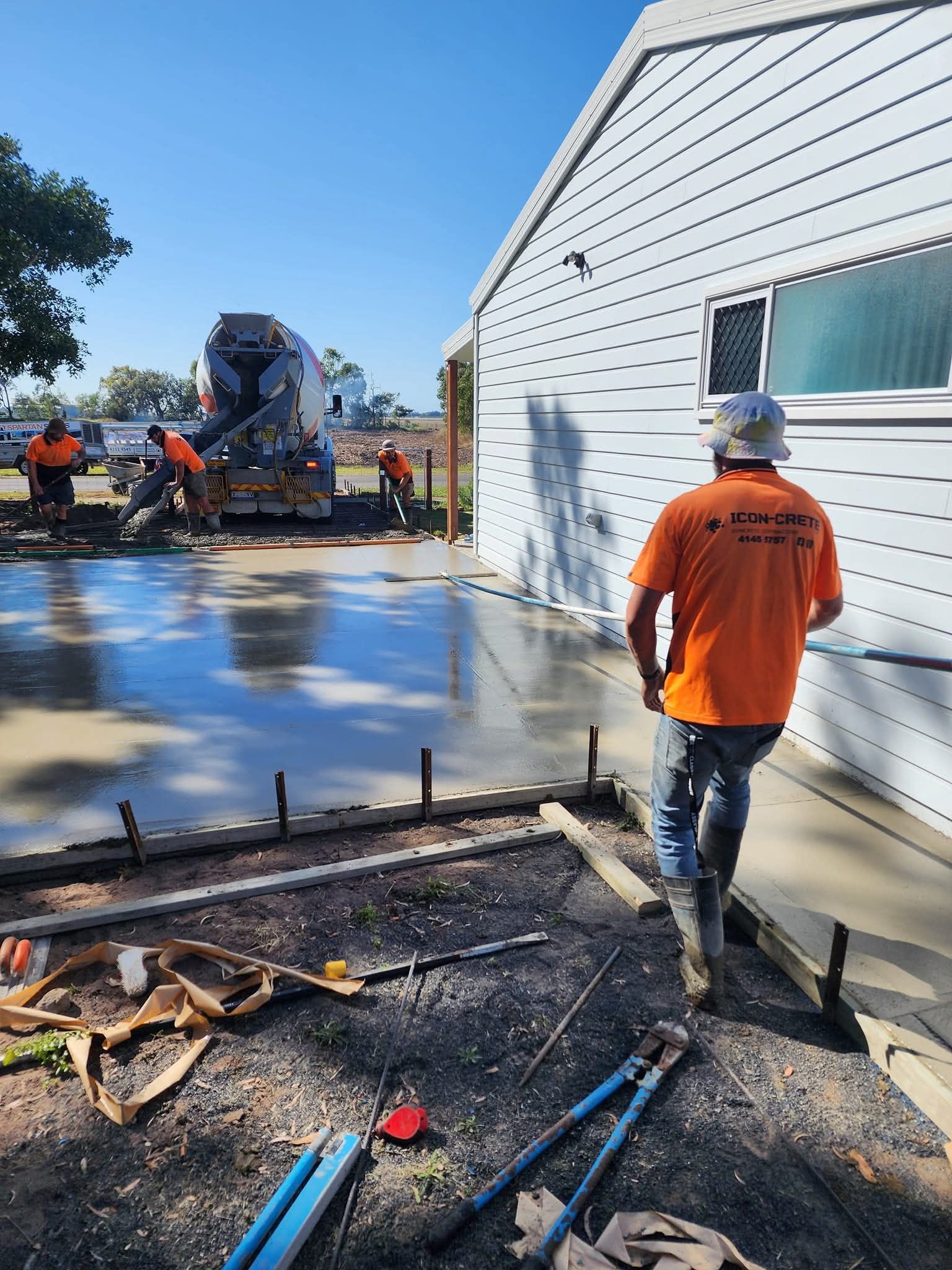 One of our valued team running the bullfloat to make sure the slab is perfectly flat.
