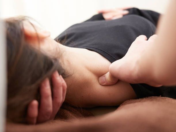 A woman is getting a massage on her leg in a spa.
