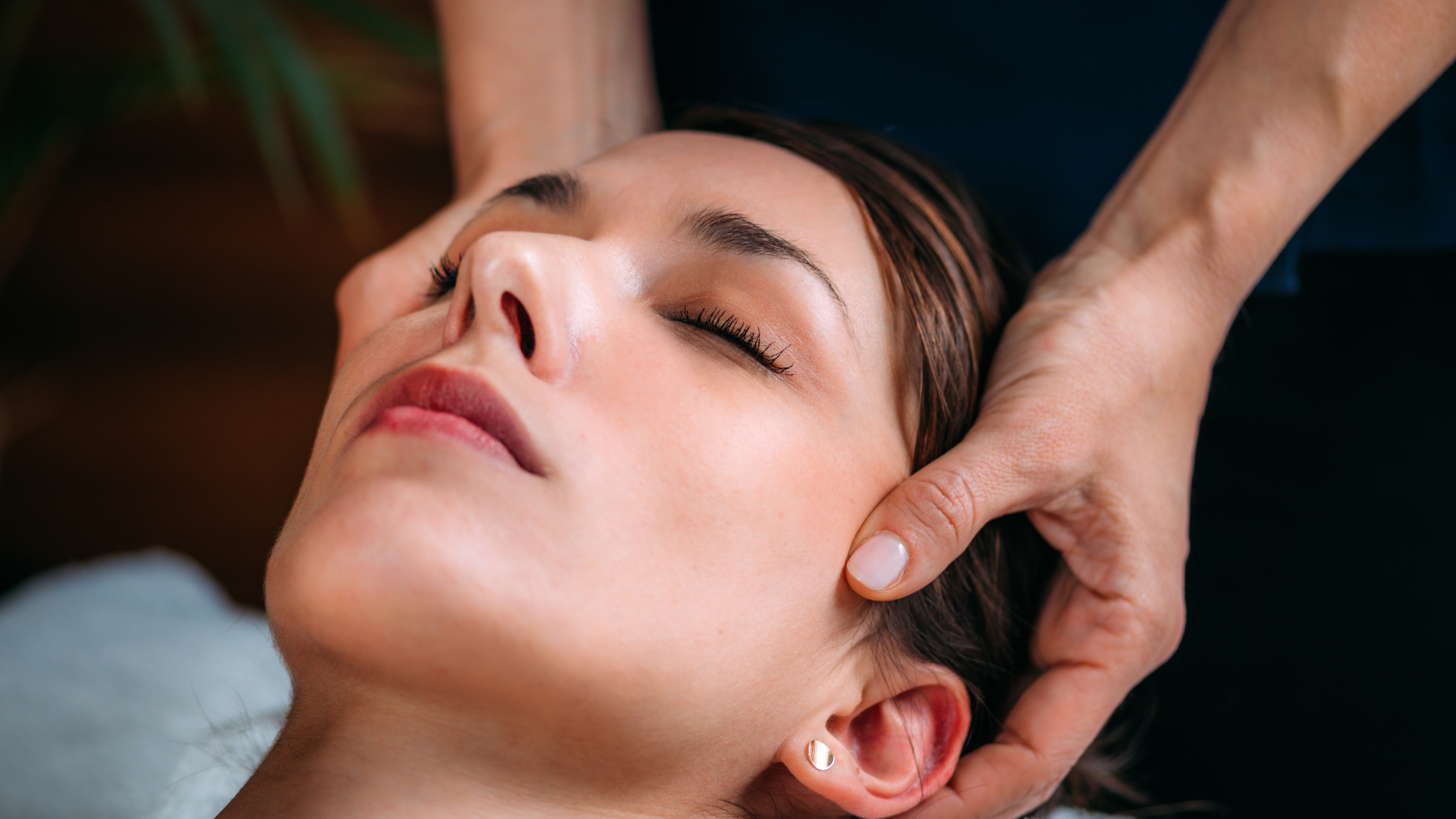 a woman is laying on a bed getting a massage from a man .