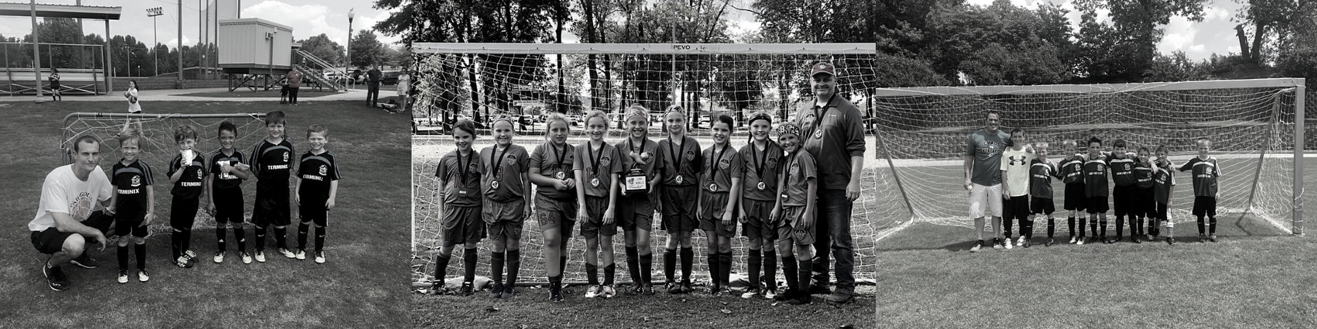 Soccer team posing on a field in black-and-white, with a goal and trees in the background