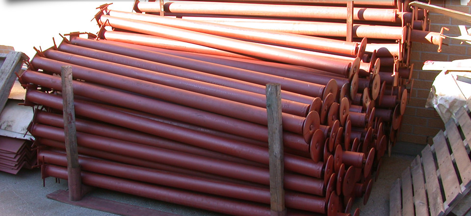A bunch of red pipes are stacked on top of each other
