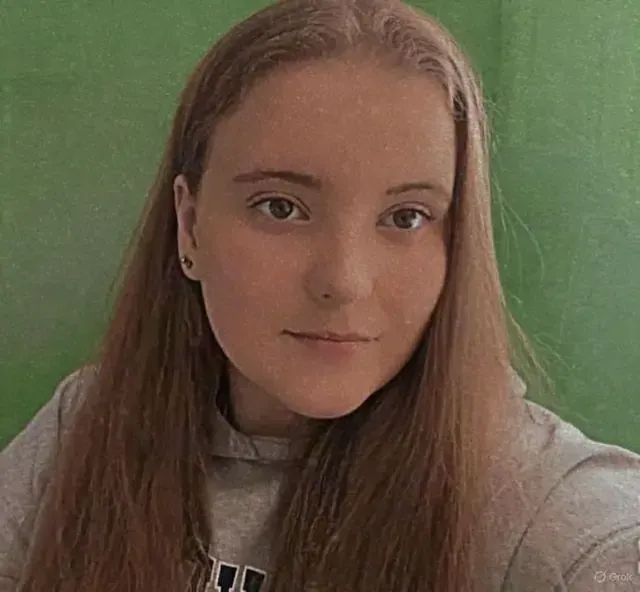 Young family assessment centre team member with long brown hair in a grey hoodie
