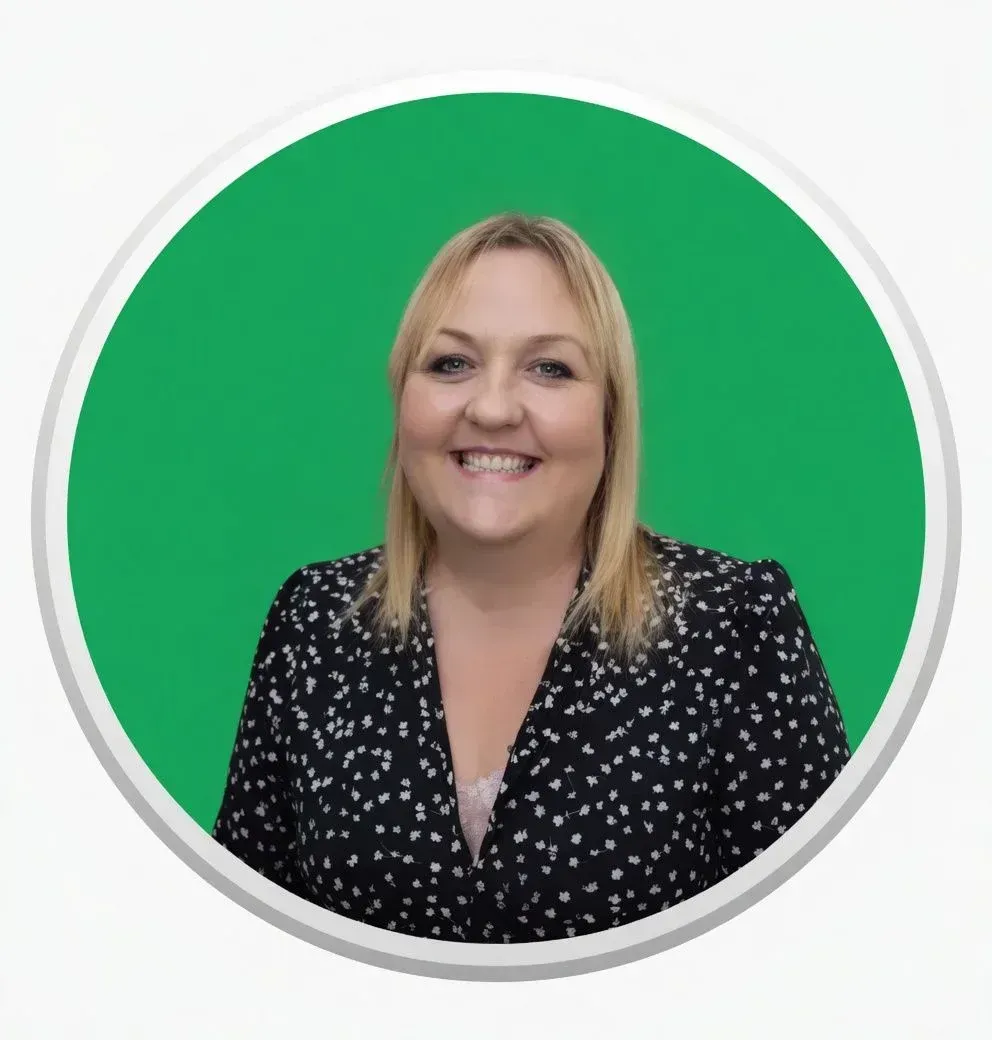 Smiling blonde family assessment centre team member in black and white floral blouse