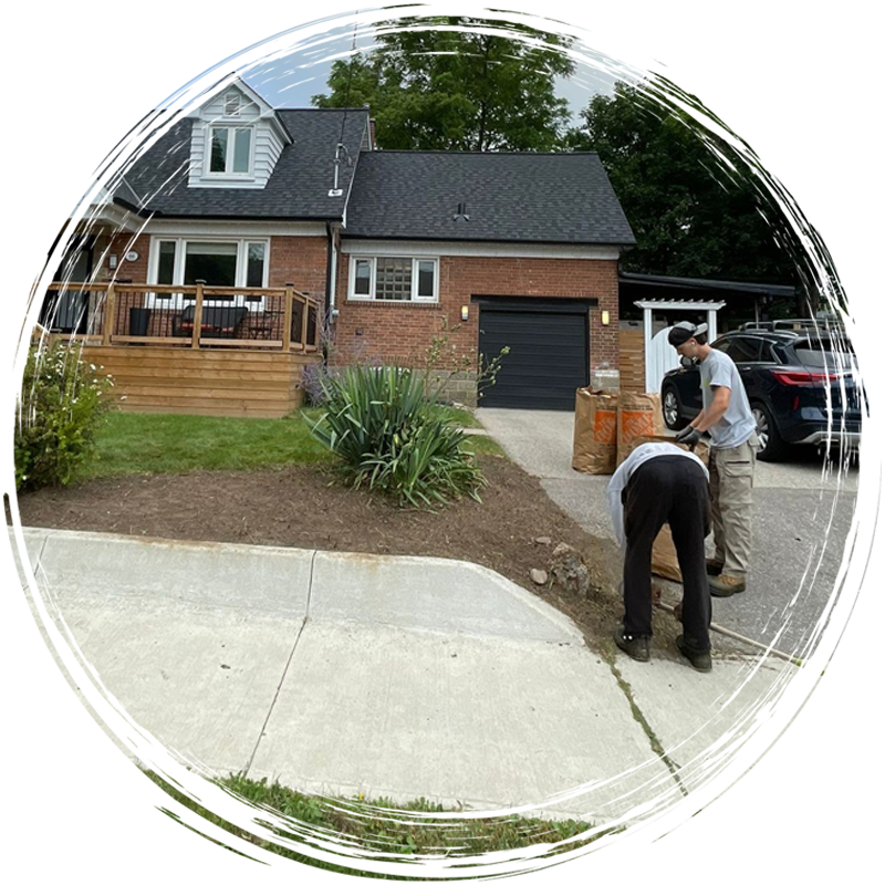 Two people work on landscaping.