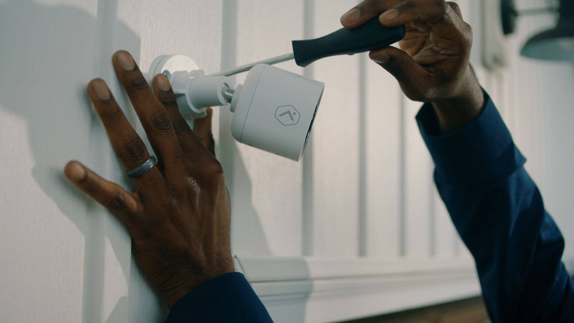 Man Installing Camera on the Wall